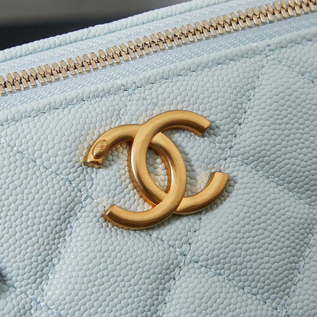Chanel light blue bag with gold CC logo medallion on the quilted front.