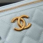 Chanel light blue bag with gold CC logo medallion on the quilted front.