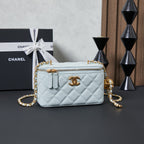 Chanel quilted mini shoulder bag, light blue with gold chain strap and zipper top.