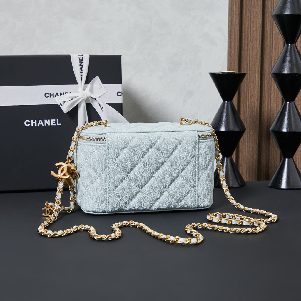 Chanel quilted mini shoulder bag, light blue with gold chain and top zipper.