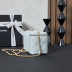 Chanel quilted crossbody bag, light blue with gold chain and small top handle.