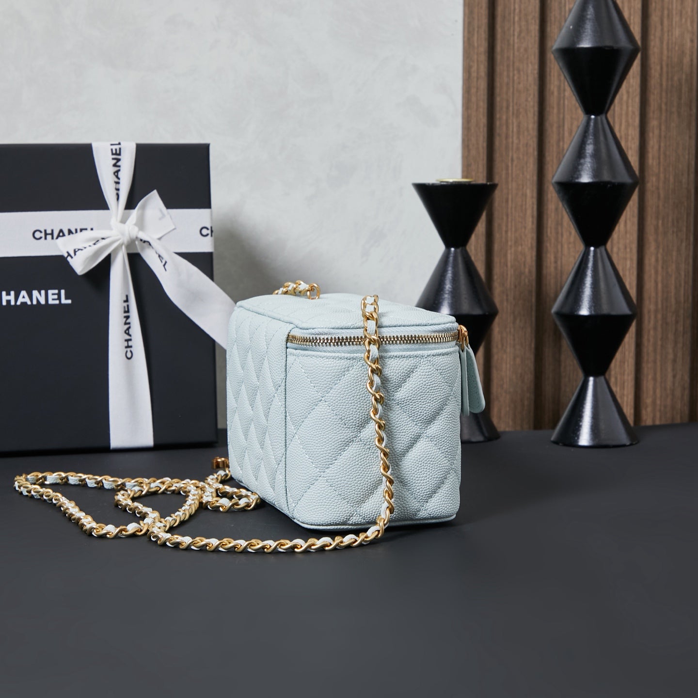 Chanel quilted crossbody bag, light blue with gold chain and small top handle.