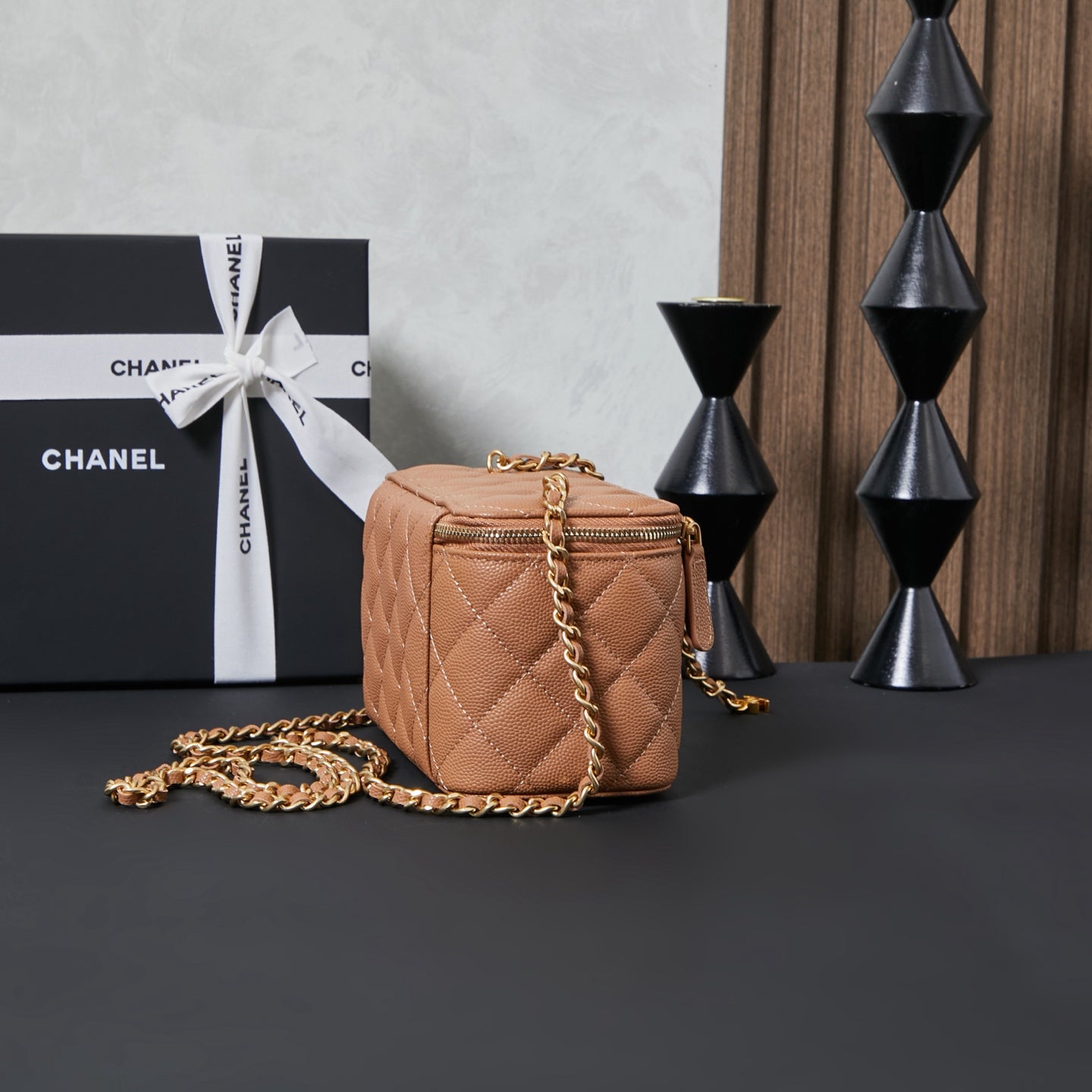 Small quilted Chanel bag with gold chain strap, tan body and zipper top