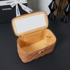 Open tan quilted Chanel mini bag with zipper, interior pocket and gold hardware