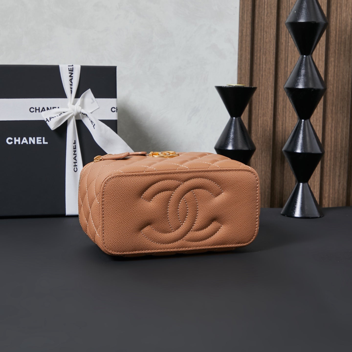 Quilted Chanel mini bag front with embossed CC logo, tan finish