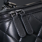 Chanel quilted leather bag close-up of zipper pulls and black leather tabs