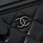 Chanel quilted leather bag close-up of metal CC turn-lock detail, black