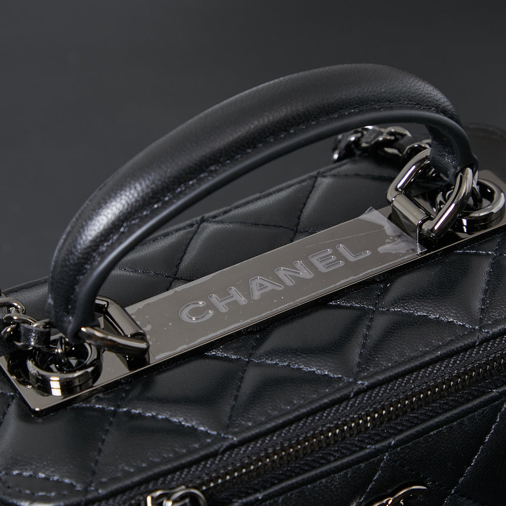 Chanel quilted leather bag detail with metal chain and embossed CHANEL strap