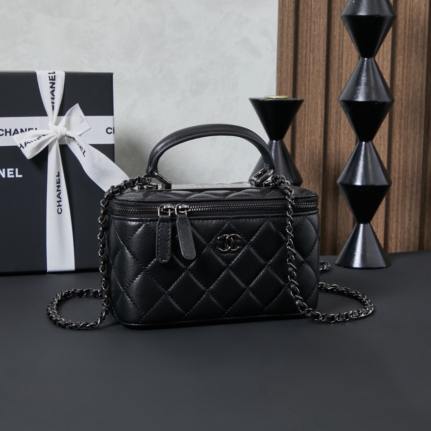 Chanel quilted leather bag with top handle and chain shoulder strap, black