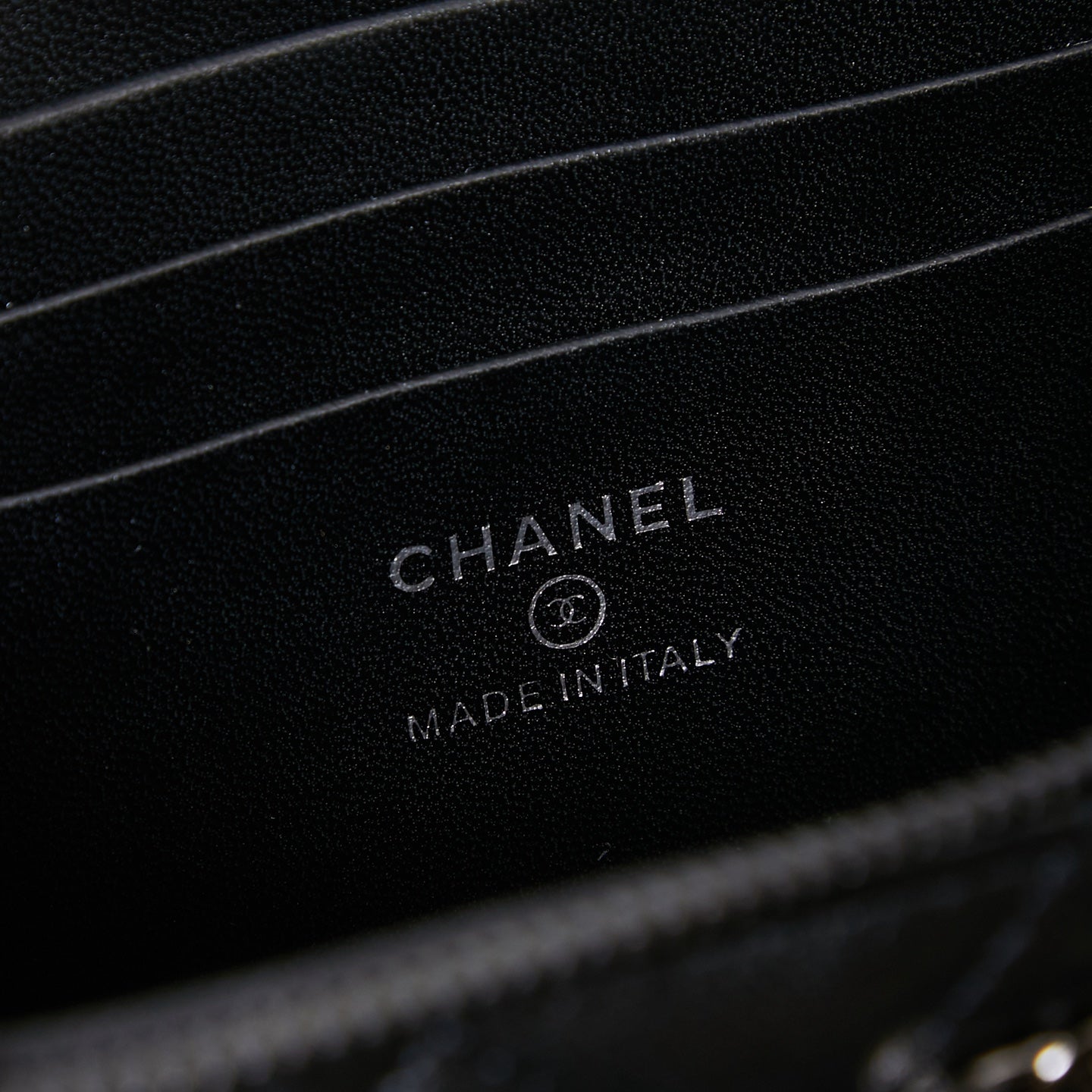 Chanel leather bag interior stamp reading CHANEL and MADE IN ITALY