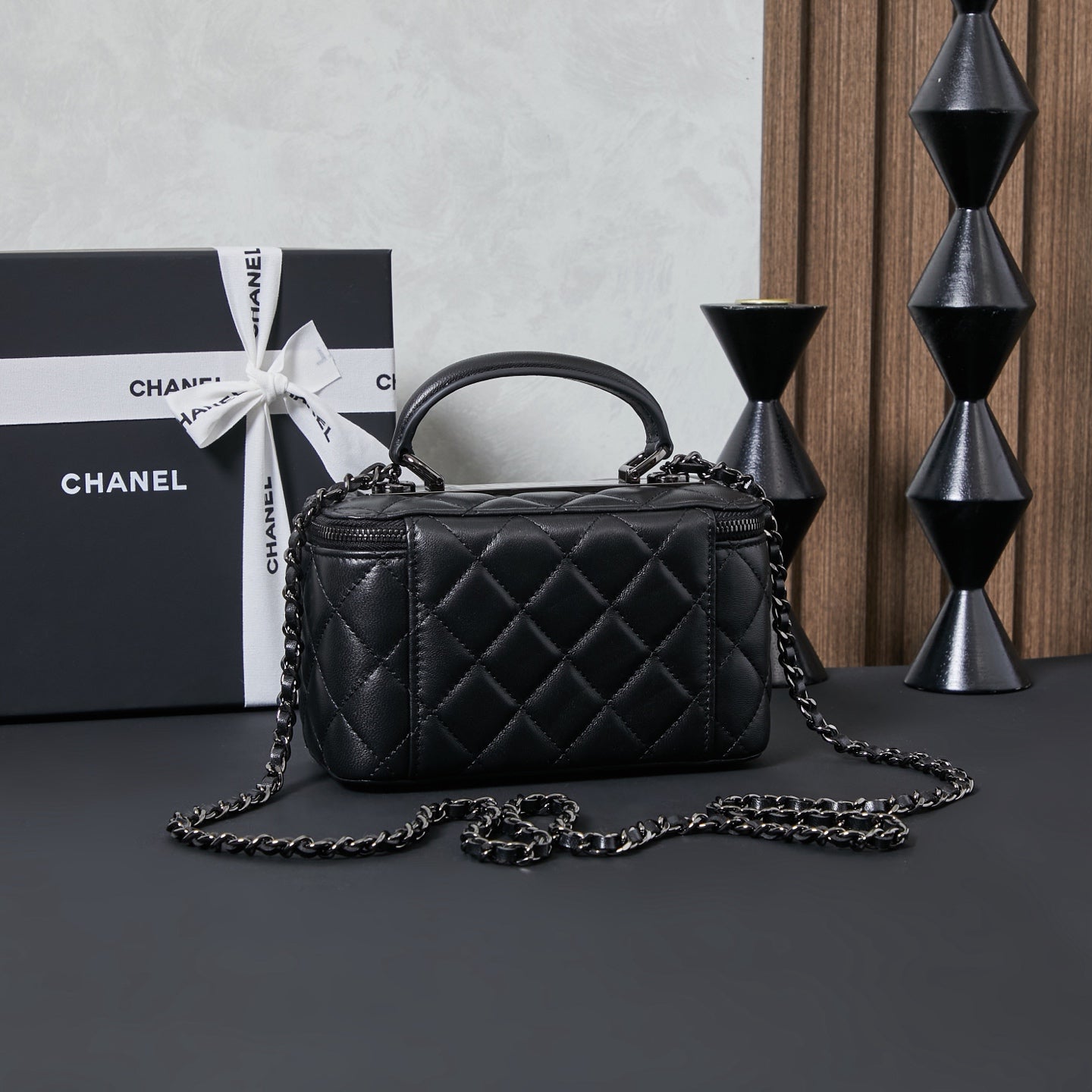 Chanel quilted leather handbag with curved top handle and chain strap, black