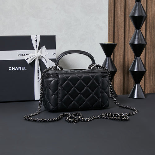 Chanel quilted leather handbag with curved top handle and chain strap, black