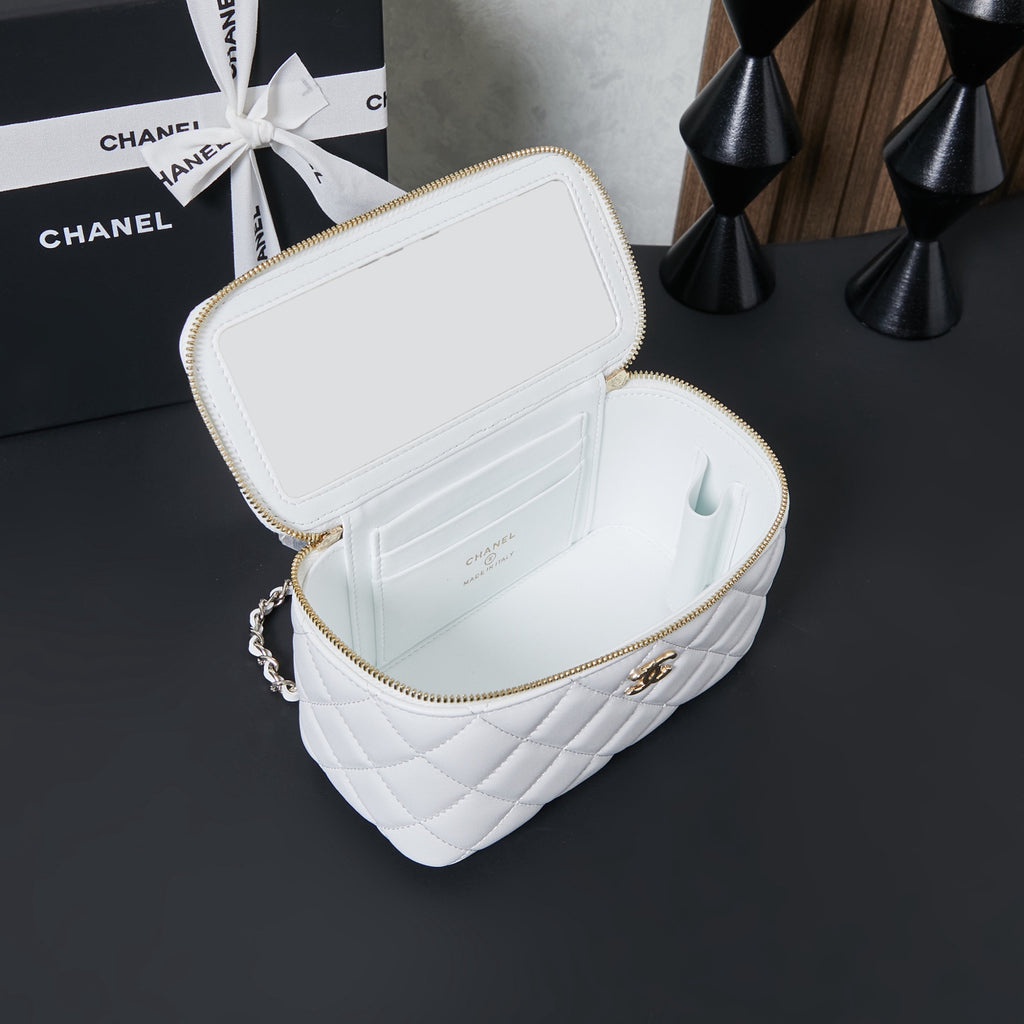 White quilted mini bag open with gold zipper and interior compartments