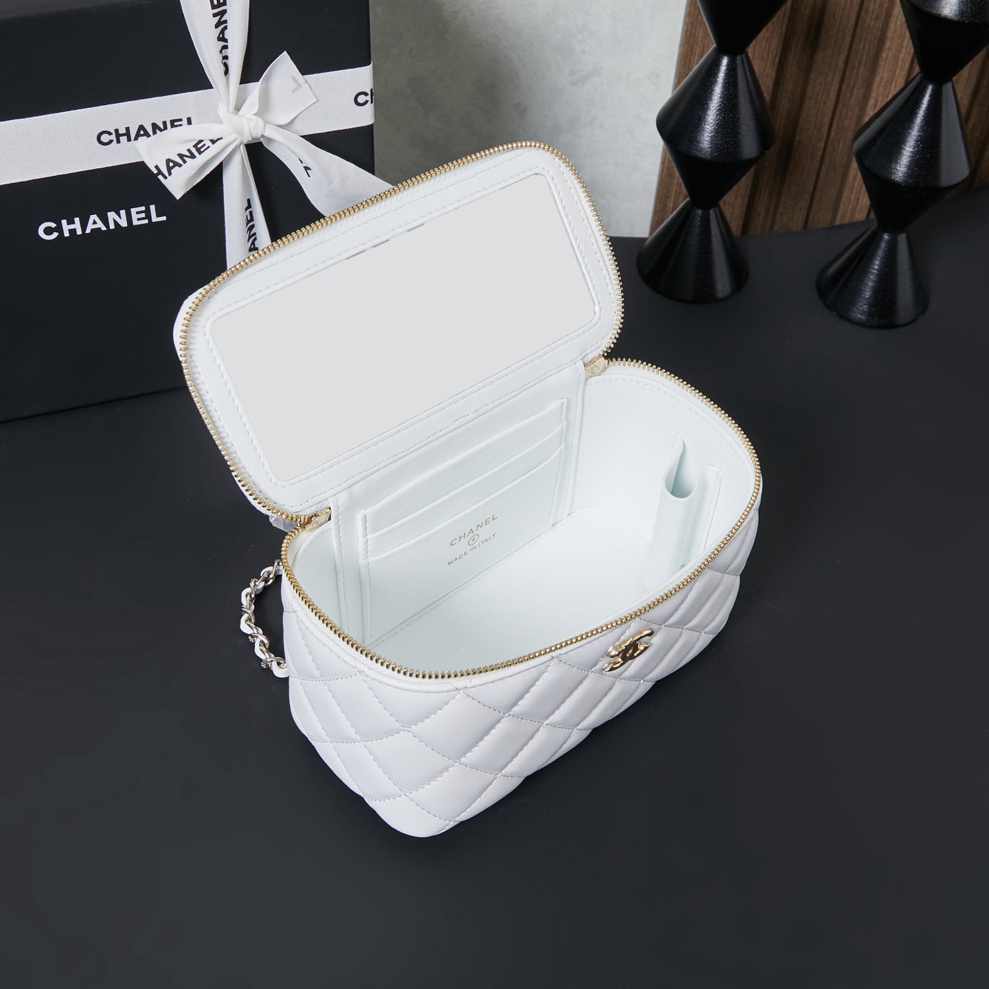 White quilted mini bag open with gold zipper and interior compartments
