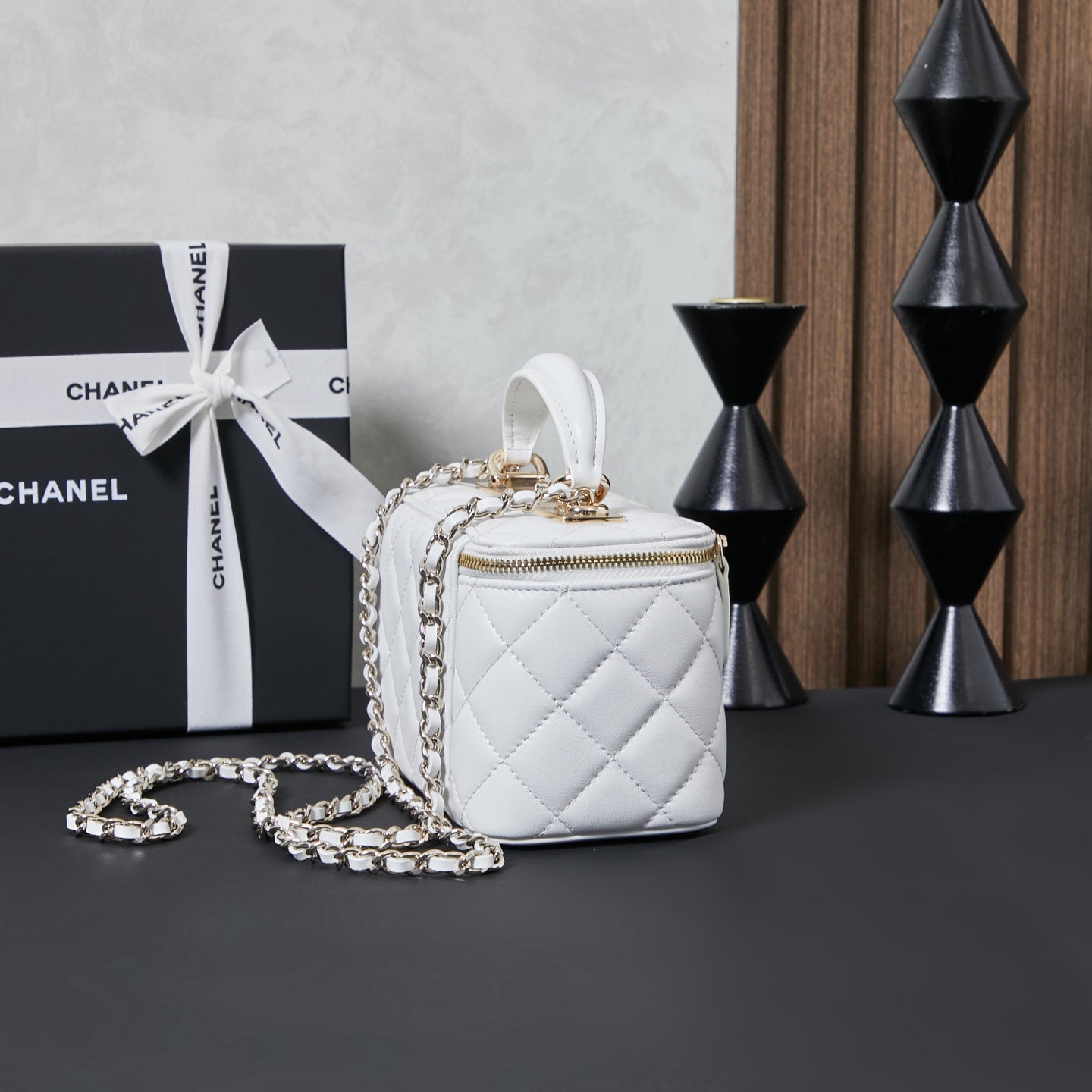 White quilted Chanel mini bag with short chain strap, side view