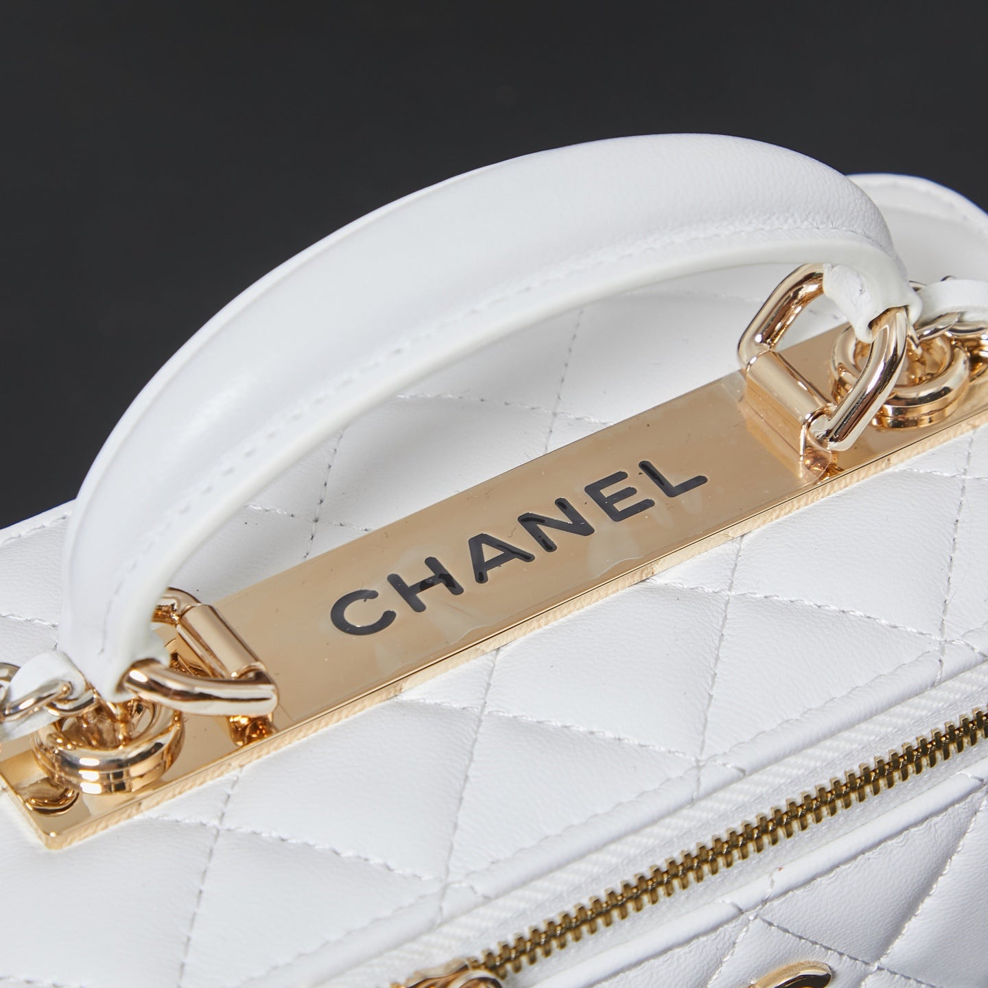 White quilted strap lining with gold CHANEL branding bar