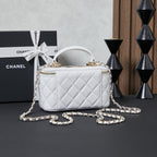 White quilted Chanel mini bag with chain strap and top handle