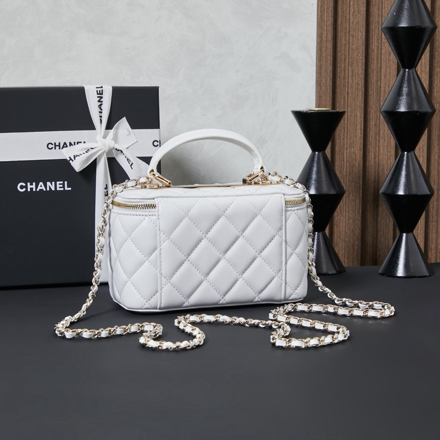White quilted Chanel mini bag with chain strap and top handle