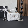 White quilted Chanel mini bag with chain shoulder strap and top handle