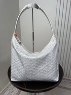Goyard white hobo bag with woven top handles and textured monogram pattern.