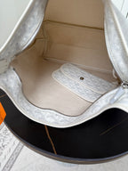 Goyard white hobo bag interior with lining and zip pocket in monogram fabric.
