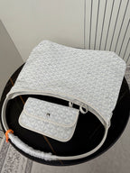 Goyard white hobo bag with matching pouch on top, monogram texture visible.