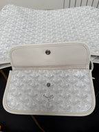 Goyard white mini pouch with monogram texture and leather flap with button.
