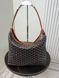 Goyard hobo bag with gray monogram pattern, orange trim, and top braided handles