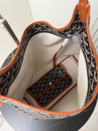 Goyard hobo bag interior view with beige lining and orange-trimmed pockets