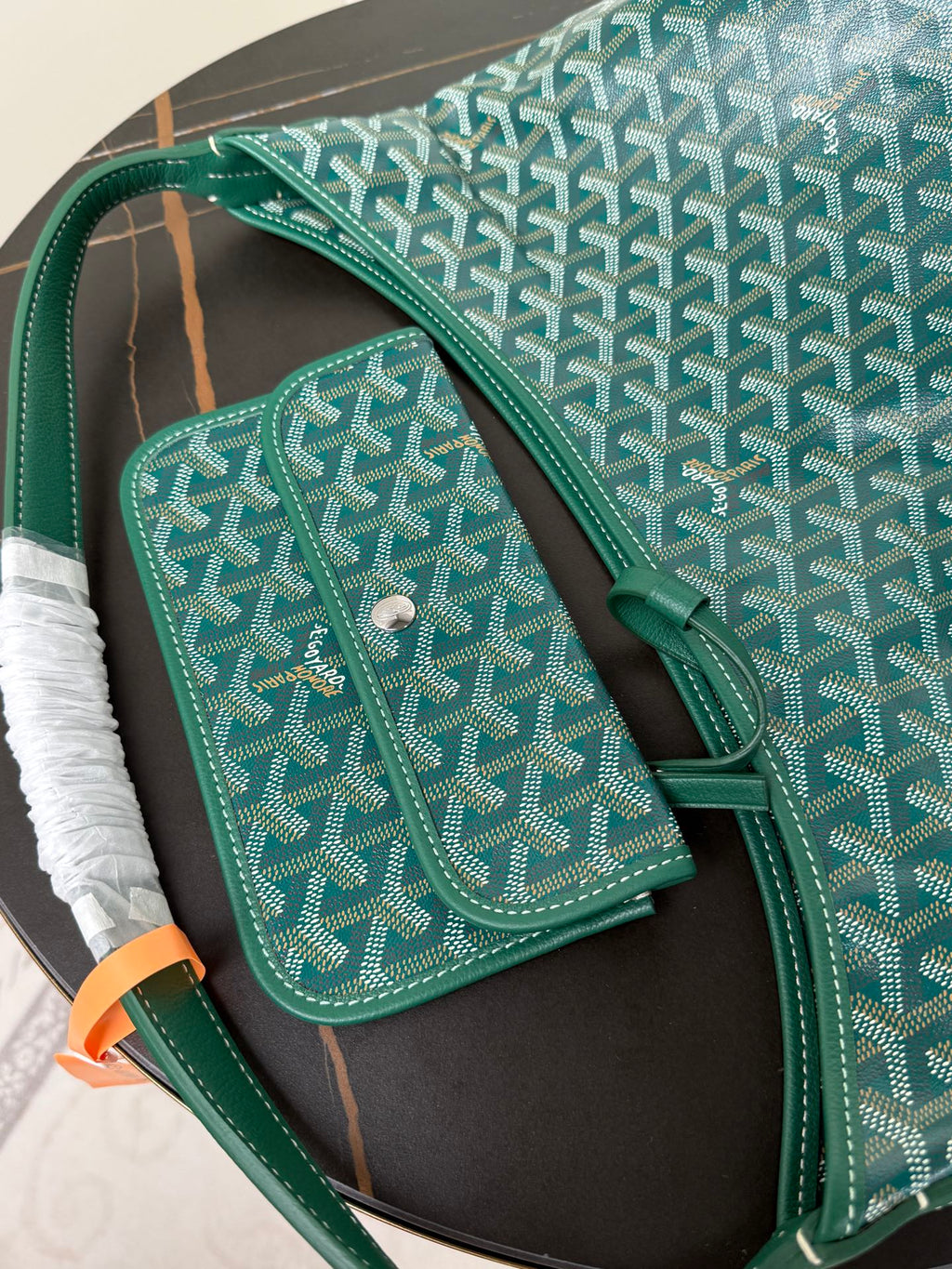 Goyard teal shoulder bag with matching small pouch on side, button closure.