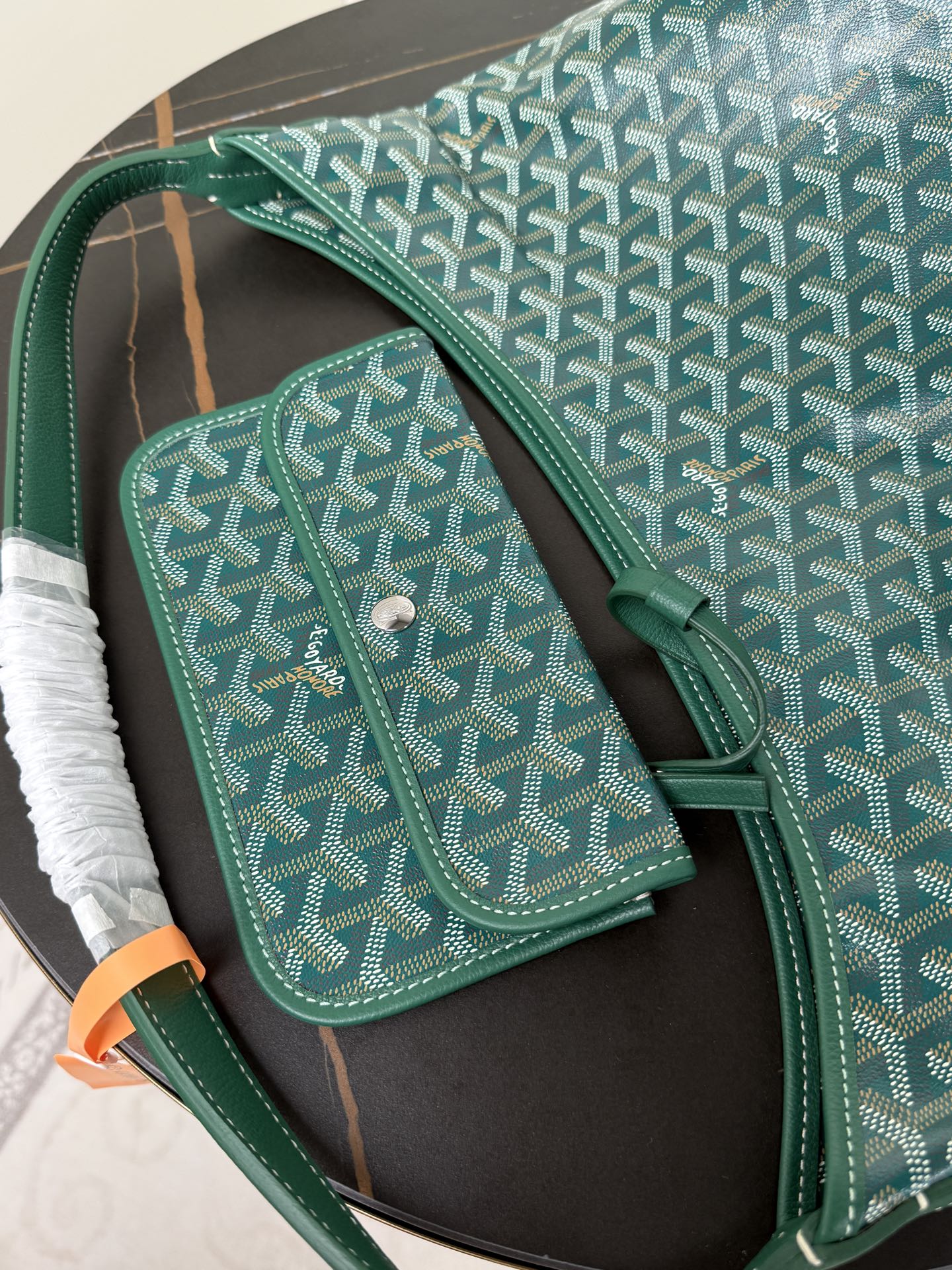 Goyard teal shoulder bag with matching small pouch on side, button closure.