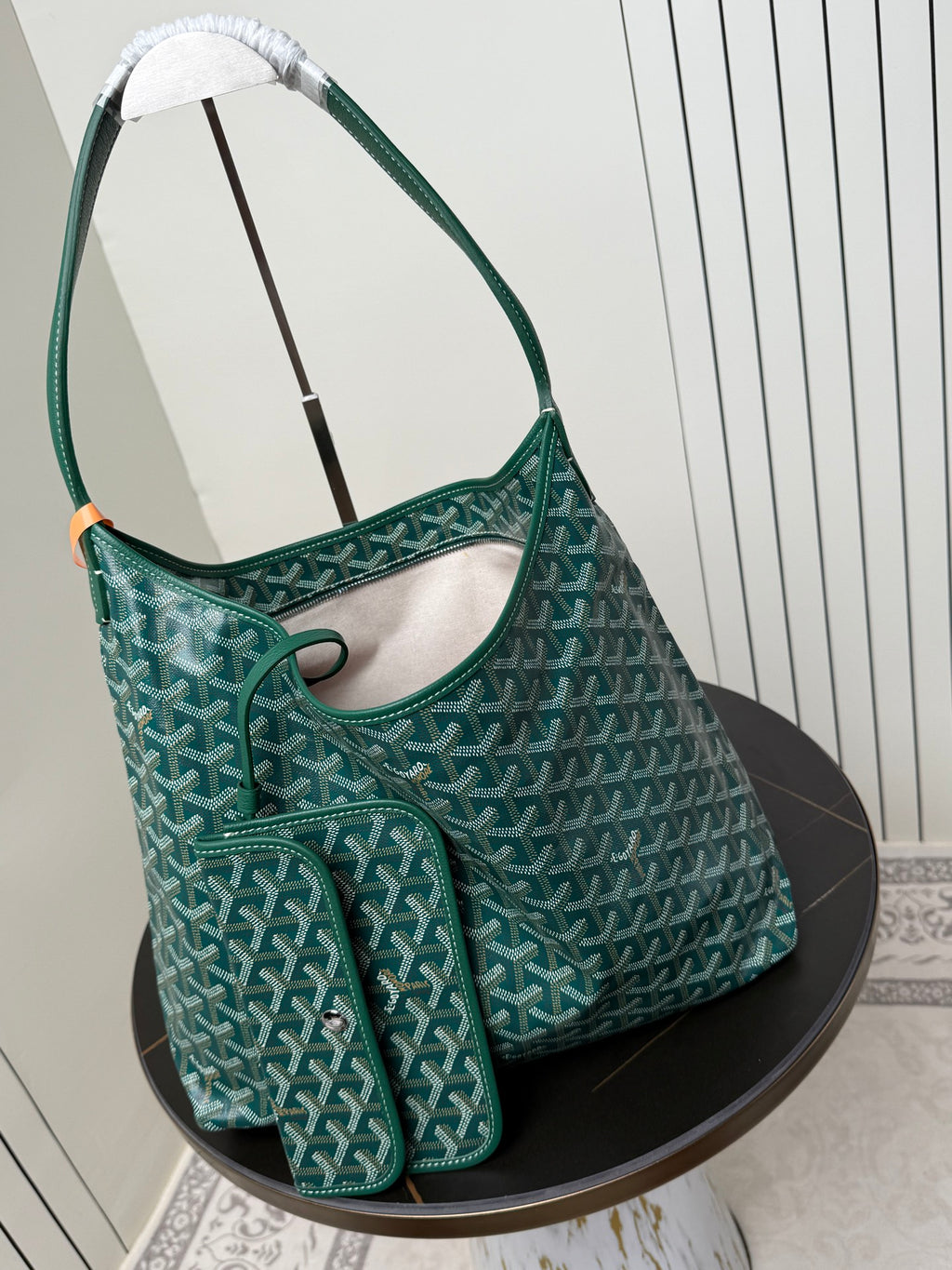 Goyard teal hobo shoulder bag with matching small pouch and patterned fabric.