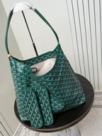 Goyard teal hobo shoulder bag with matching small pouch and patterned fabric.