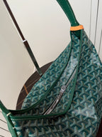 Goyard teal shoulder bag detail with front zip pocket and patterned Goyardine fabric.