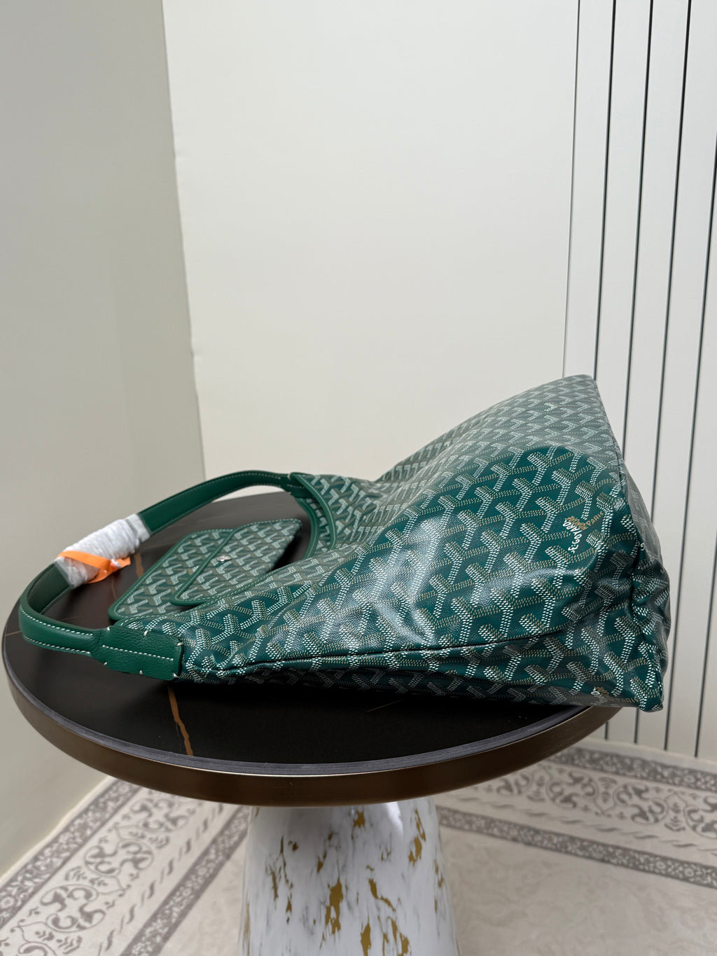 Goyard teal hobo shoulder bag with top handle and patterned Goyardine fabric, side view.