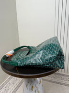 Goyard teal hobo shoulder bag with top handle and patterned Goyardine fabric, side view.