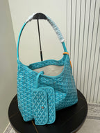 Goyard teal monogram hobo bag with interior lining and side pocket