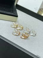 Assorted butterfly stud earrings with white mother-of-pearl petals in gold-tone settings