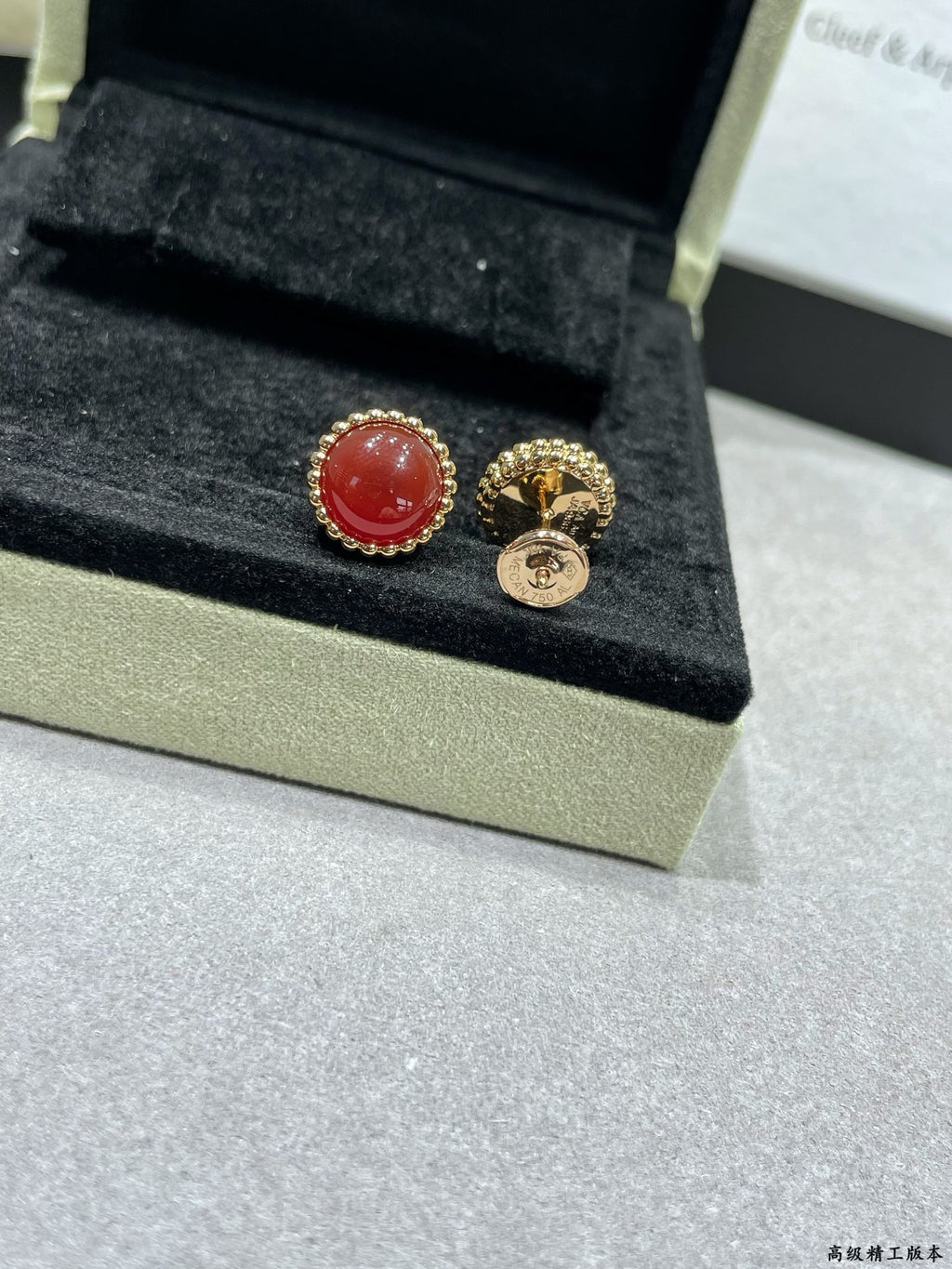 Van Cleef & Arpels earrings, red round stud and gold-tone hoop with emblem