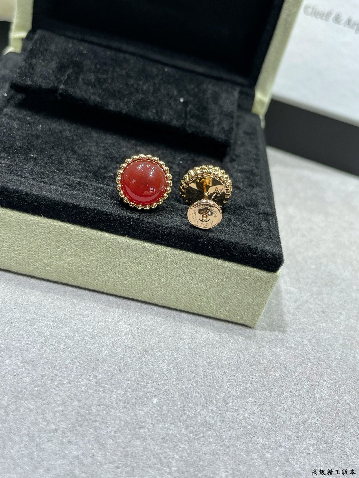 Van Cleef & Arpels earrings, red round stud and gold-tone hoop with emblem