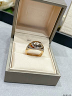 Gold-tone ring with oval center stone and diamond-look pavé band in a gift box