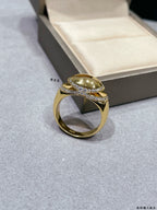 Gold-tone oval-stone ring with pavé band, shown at an angled top view
