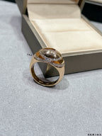 Gold-tone ring with oval center stone and pavé diamond-look band on display