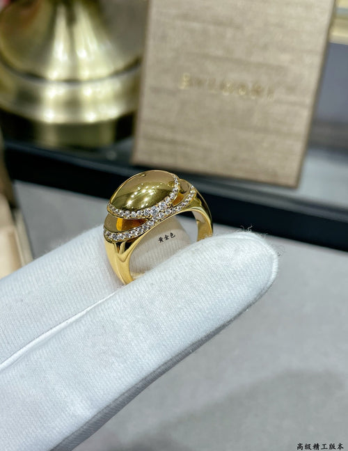 Gold-tone ring with large oval center stone and pavé diamond-look band