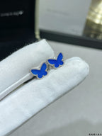 Pair of butterfly stud earrings with blue enamel on silver-tone posts