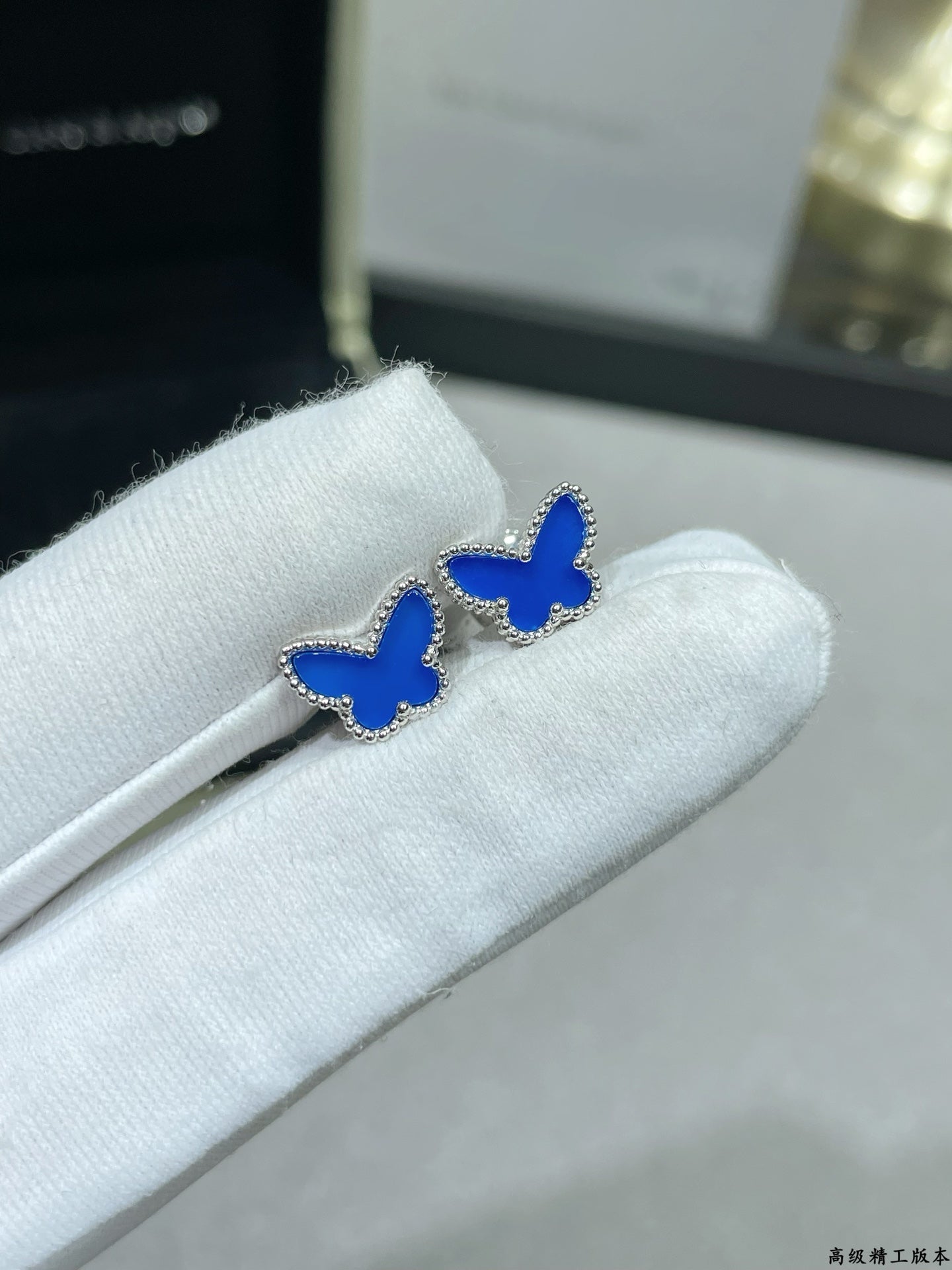 Pair of butterfly stud earrings with blue enamel on silver-tone posts