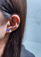 Butterfly stud earrings with blue enamel on a silver-tone setting