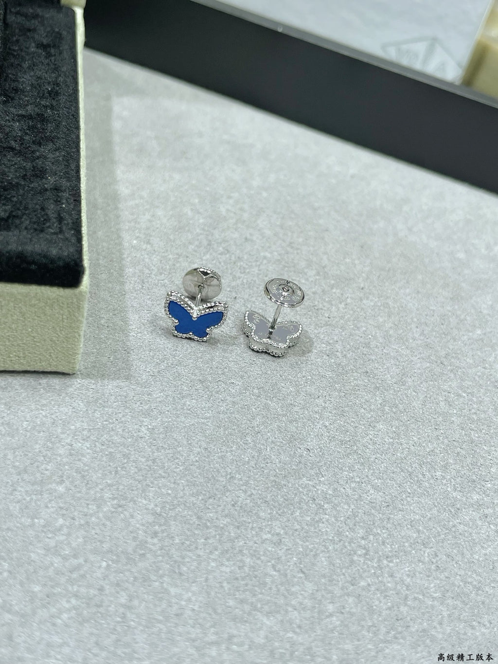 Butterfly stud earrings with one blue enamel butterfly and one silver-tone butterfly