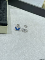 Butterfly stud earrings with one blue enamel butterfly and one silver-tone butterfly