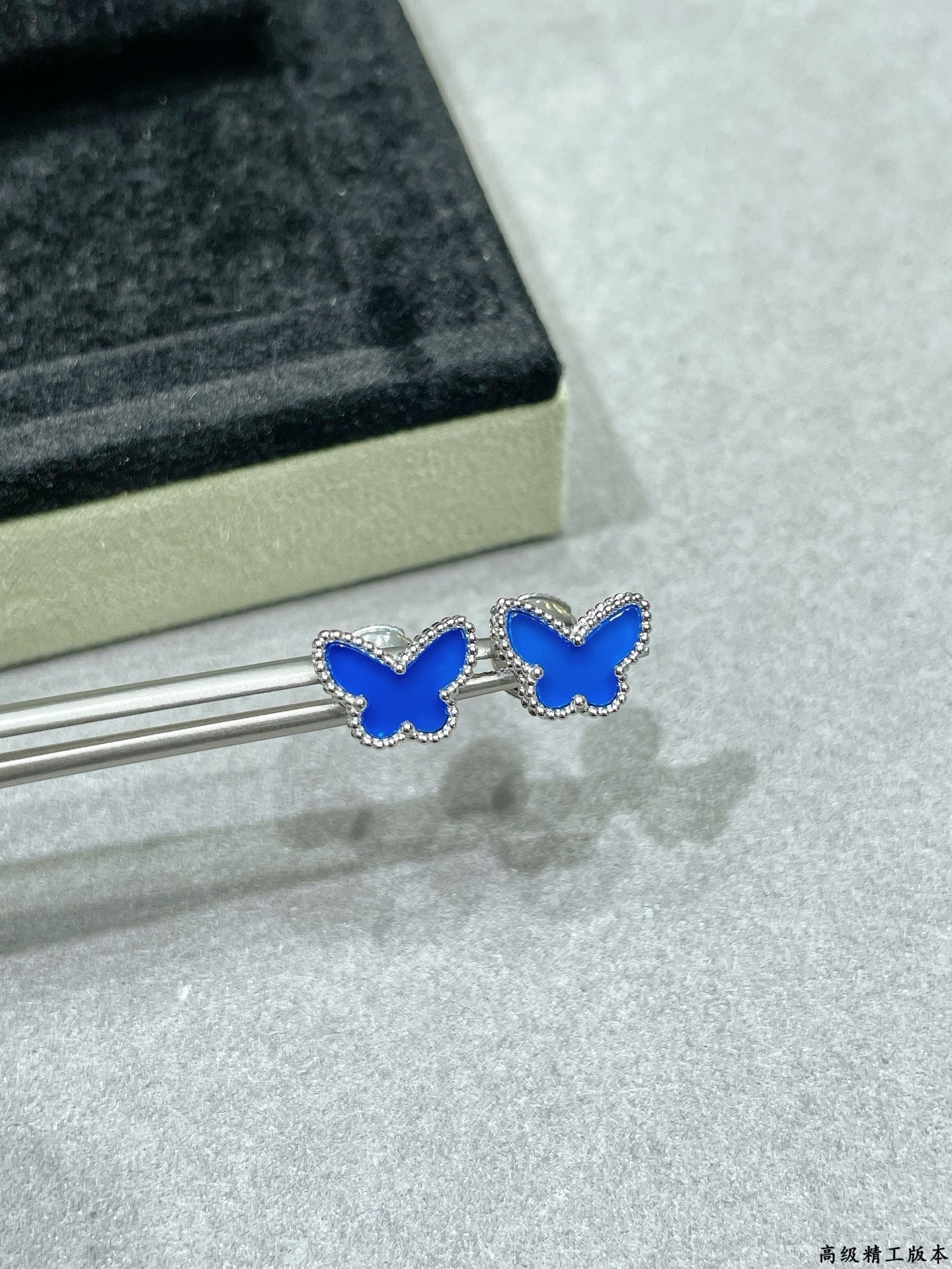 Pair of butterfly stud earrings with blue enamel and clear stone details